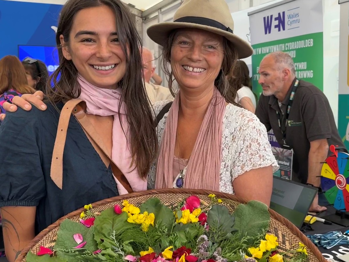 Young woman and employer with home grown produce
